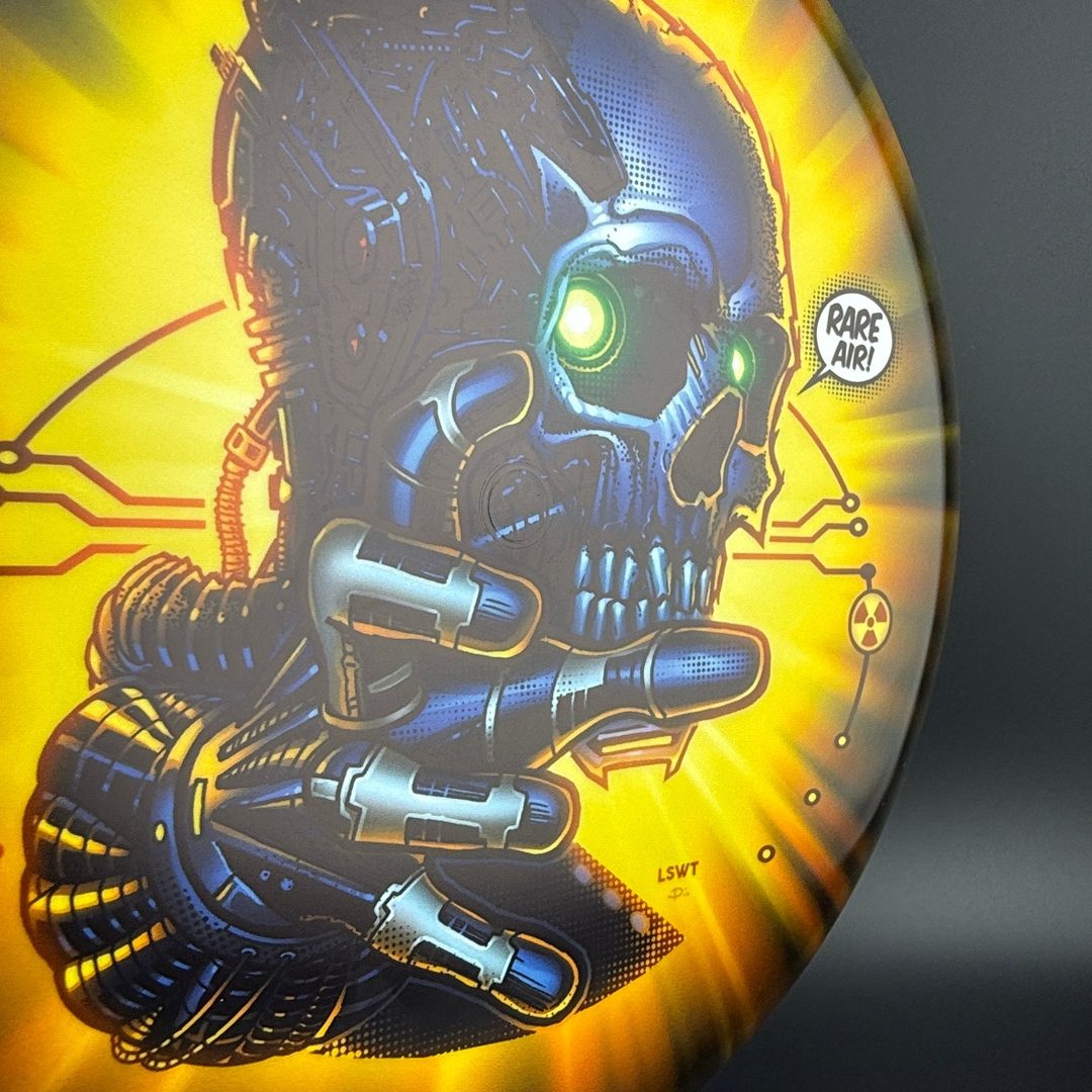 Gold Pure disc golf disc from Rare Air Discs' Stratus Fear V3 by Les White & Dan Kemp, featuring a gold color and detailed design.