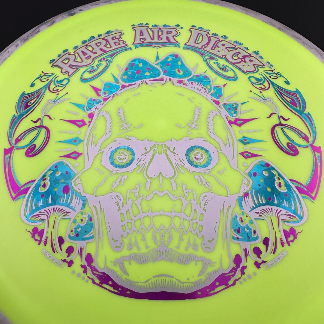 Fission Defy Crushin' Amanitas VIP 2.0 disc golf disc by Rare Air Discs, showcasing the colorful, detailed design on the flight disc.