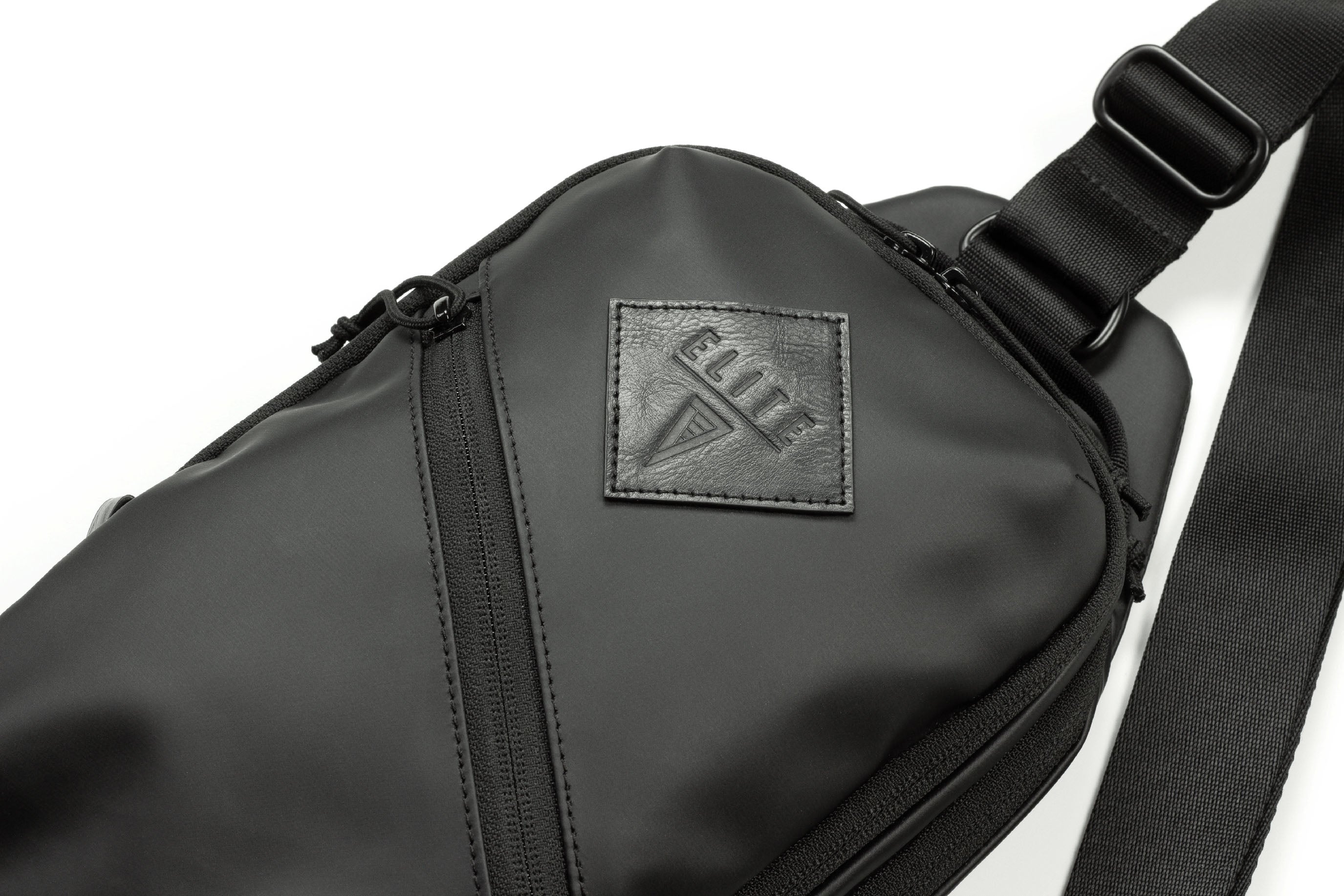 Close-up of the Elite Survival Systems SENTINEL cross-body concealment pouch with zippers and adjustable strap.