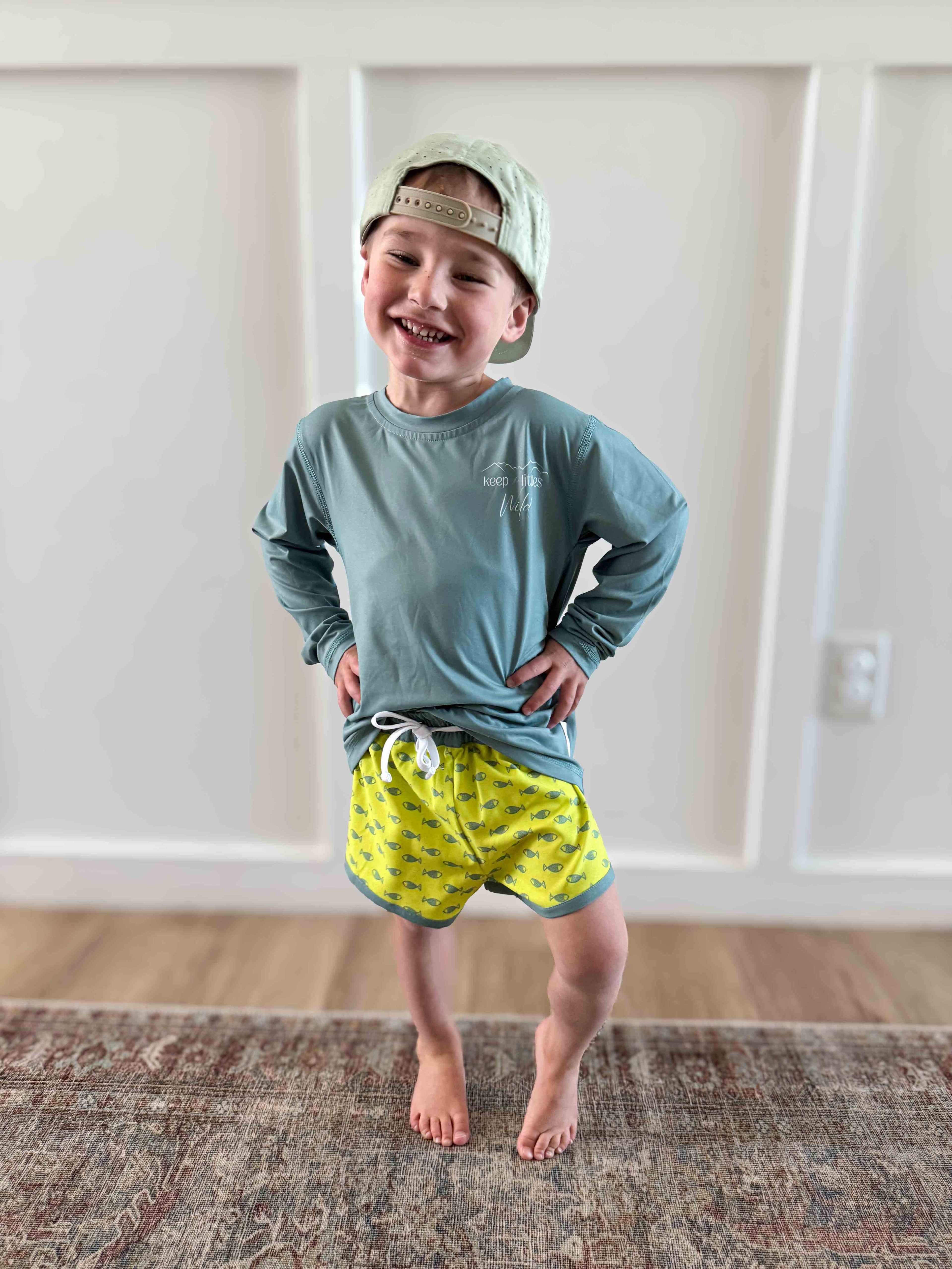 Neon fish hybrid shorts by Keep the Littles Wild with vibrant fish print, casual fit, and bright neon colors.