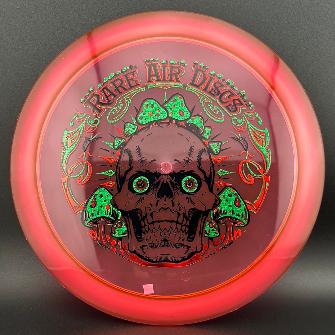 Disc golf stamp by Manny Trujillo featuring Crushin' Amanitas design on a Rare Air Discs Ethos Construct disc.