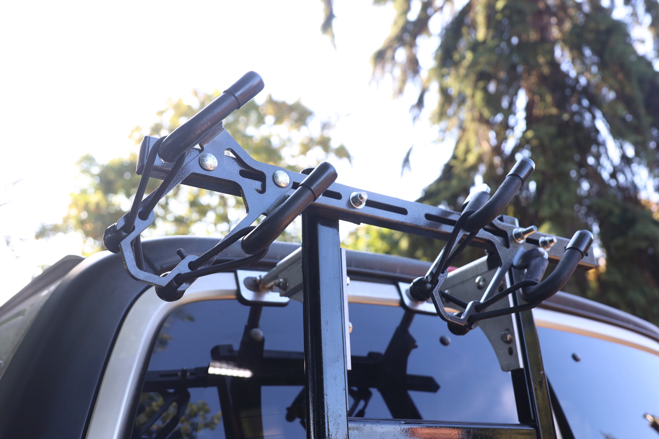Lolo Racks Rad Lad bike rack kit mounted on rear ladder, showcasing secure attachment and mounting hardware for bicycle transport.