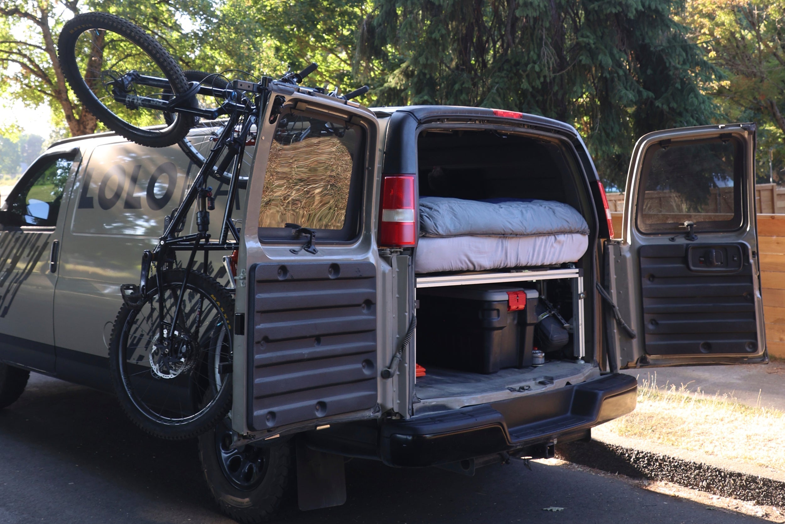 Lolo Racks Rad Lad rear ladder bike rack kit installed on vehicle, showing sturdy mounting and bike support arms.