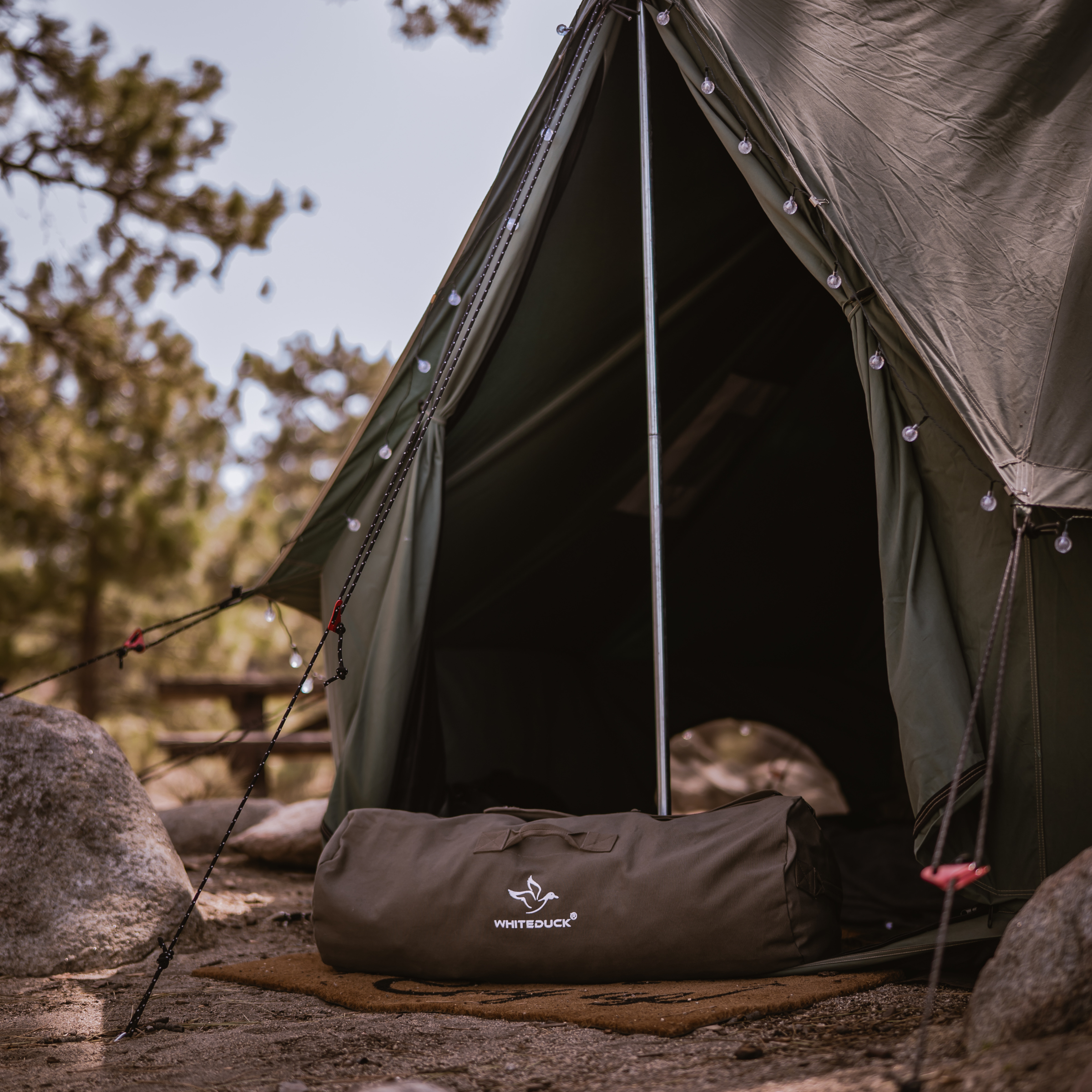 White Duck Outdoors Hoplite Canvas Duffel Bag with sturdy handles and spacious interior, perfect for travel and outdoor adventures.