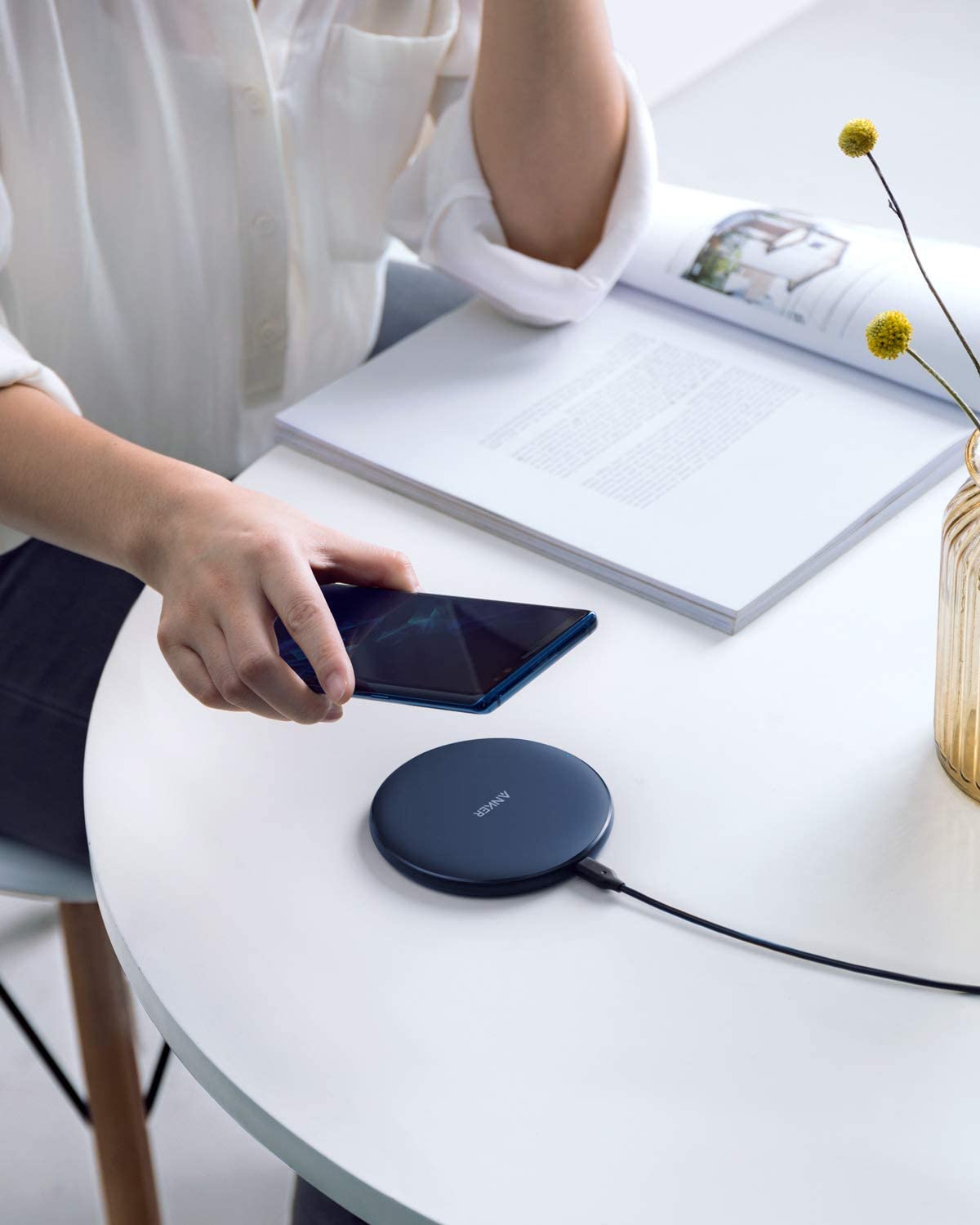 Anker 313 Wireless Charger pad on a surface, designed for efficient charging of compatible devices.