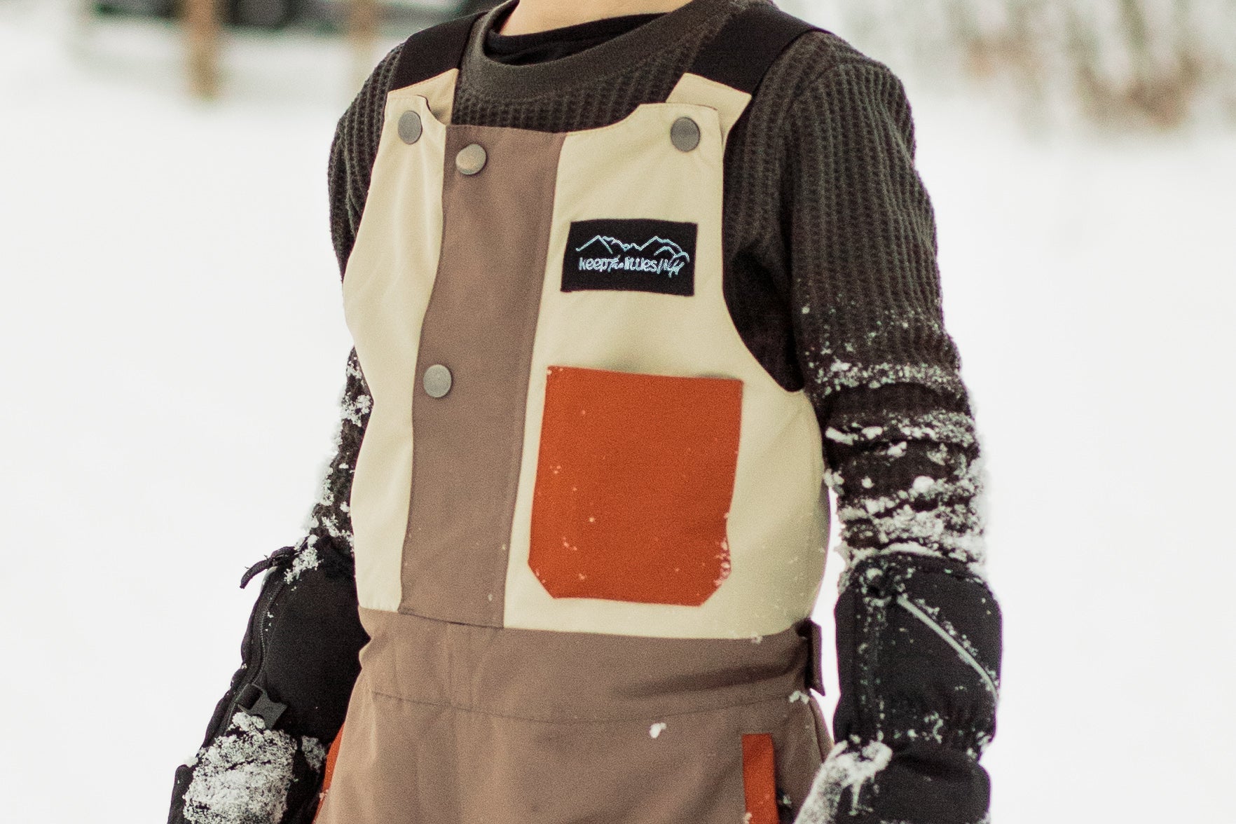 Waterproof snow bib for youth and toddlers by Keep the Littles Wild, featuring adjustable straps and snow-resistant fabric.