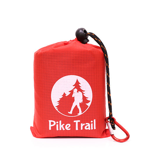 Pike Trail pocket blanket spread out on grass, compact and lightweight outdoor blanket for picnics and outdoor activities.