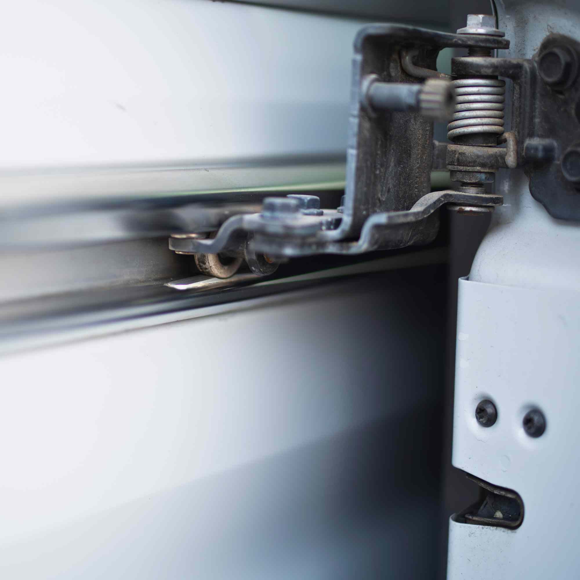Universal mid-door slider kit from The Van Mart, featuring metal components and sliding mechanism for vehicle door installation.