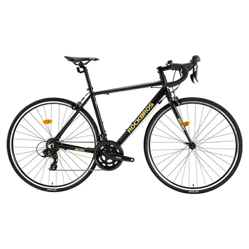 RockBros-US AERIX Aluminum Road Bike with lightweight frame, drop handlebars, and racing tires on a smooth road.