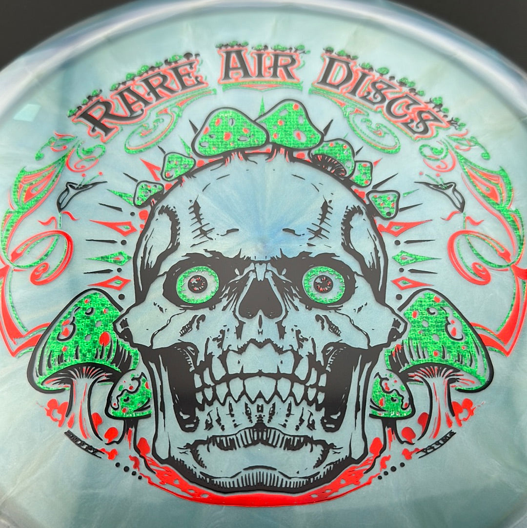 Disc golf stamp by Manny Trujillo on Rare Air Discs Ethos Construct Crushin' Amanitas disc with detailed mushroom artwork.