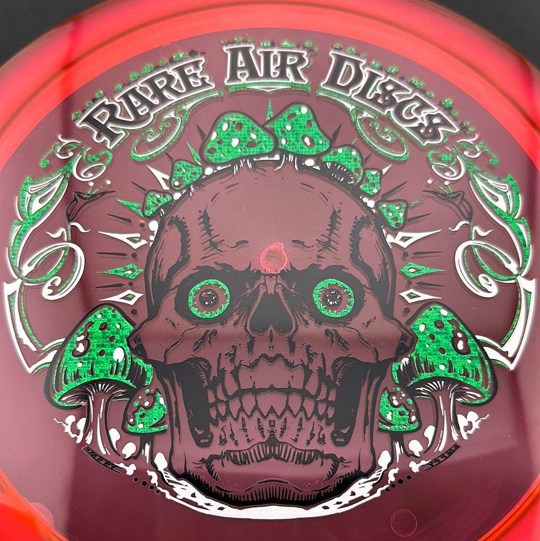 Disc golf stamp by Manny Trujillo on Rare Air Discs Ethos Construct Crushin' Amanitas disc featuring colorful mushroom artwork.