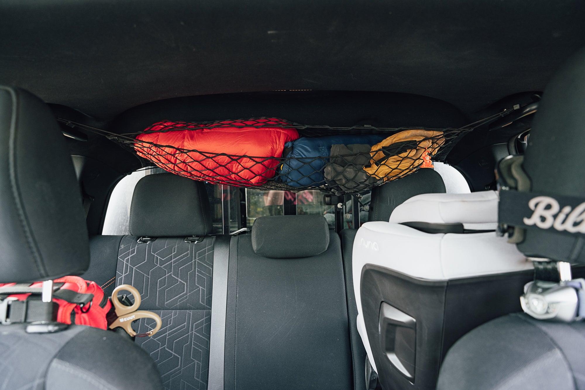 Toyota Tacoma attic storage net by Flatirons Overland, shown installed in the truck’s cargo area for secure overhead storage.