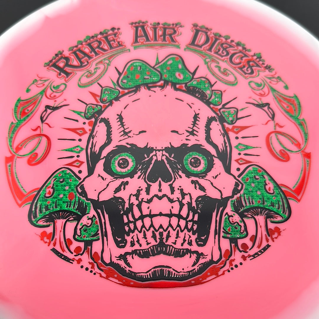 Disc golf disc from Rare Air Discs, Halo S-Blend Tomb - Crushin' Amanitas stamp, featuring vibrant artwork on a durable disc.