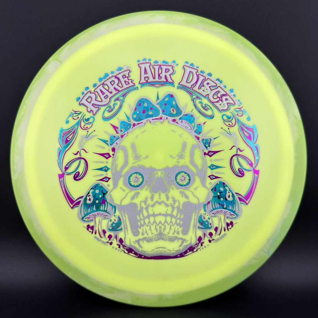 Rare Air Discs Fission Defy Crushin' Amanitas VIP 2.0 disc golf disc with vibrant green and yellow design, showcasing bold graphics.