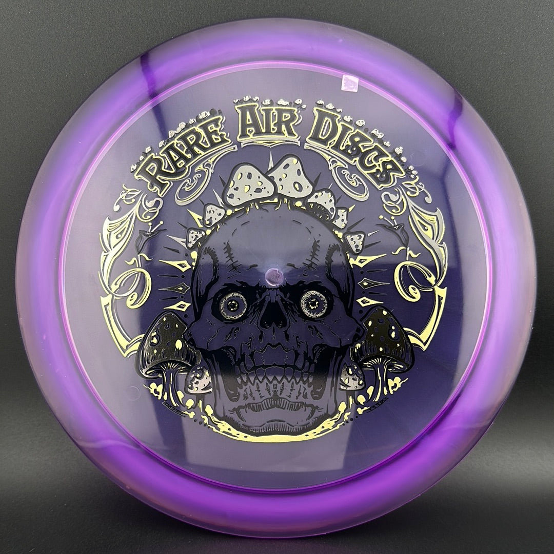 Disc golf stamp by Manny Trujillo on Rare Air Discs' Ethos Construct Crushin' Amanitas disc with colorful mushroom design.