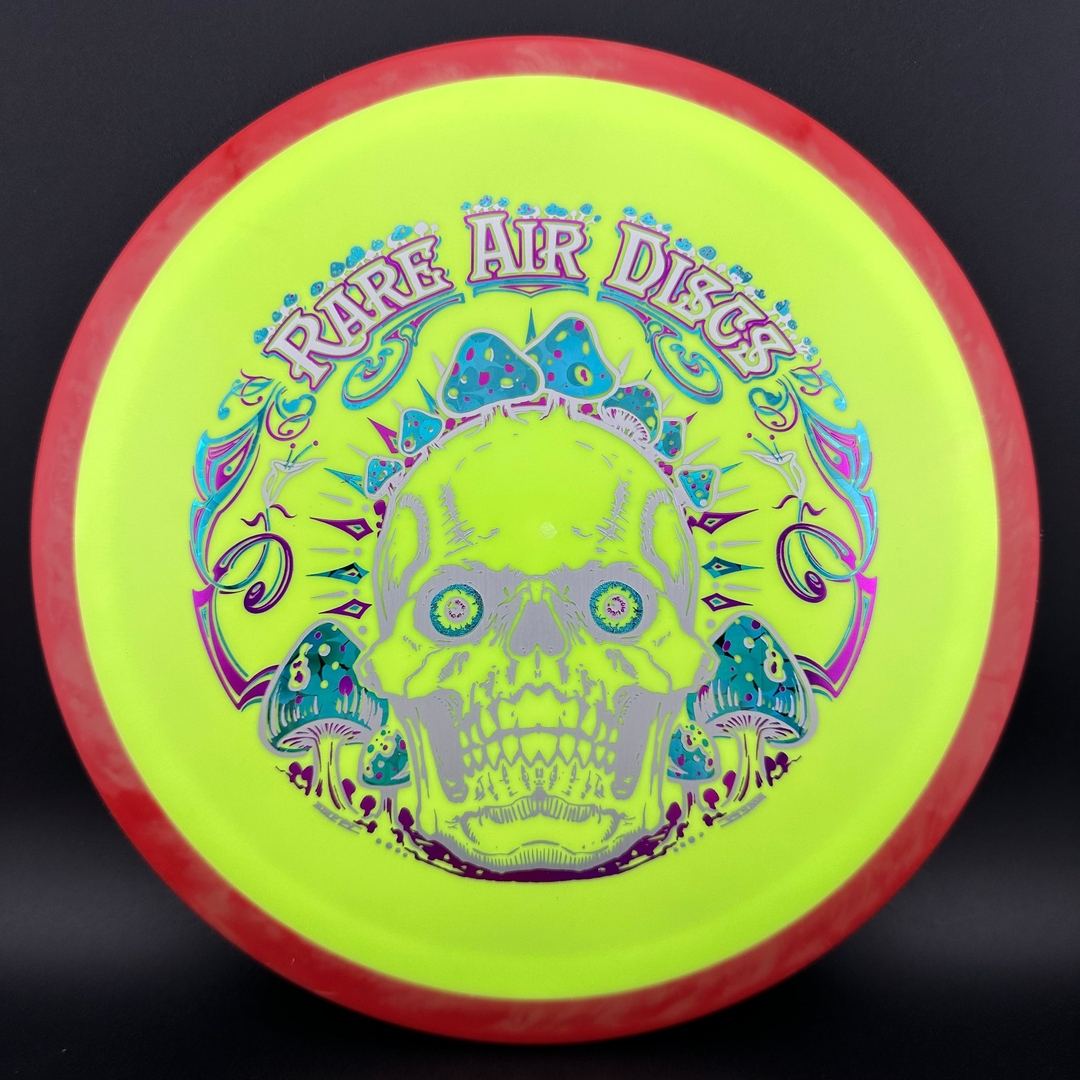 Rare Air Discs Fission Defy Crushin' Amanitas VIP 2.0 disc golf disc with vibrant design and detailed artwork by Manny Trujillo