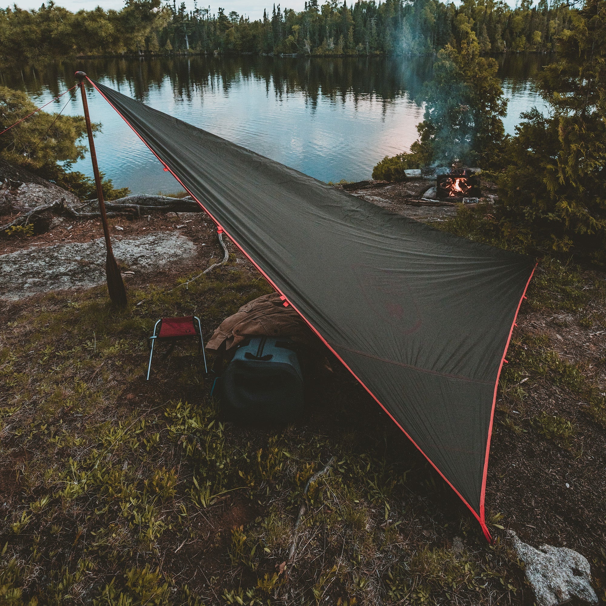 GrandTrunk Abrigo Rain Fly and Shelter set up outdoors, showcasing waterproof fabric and lightweight design for camping protection.