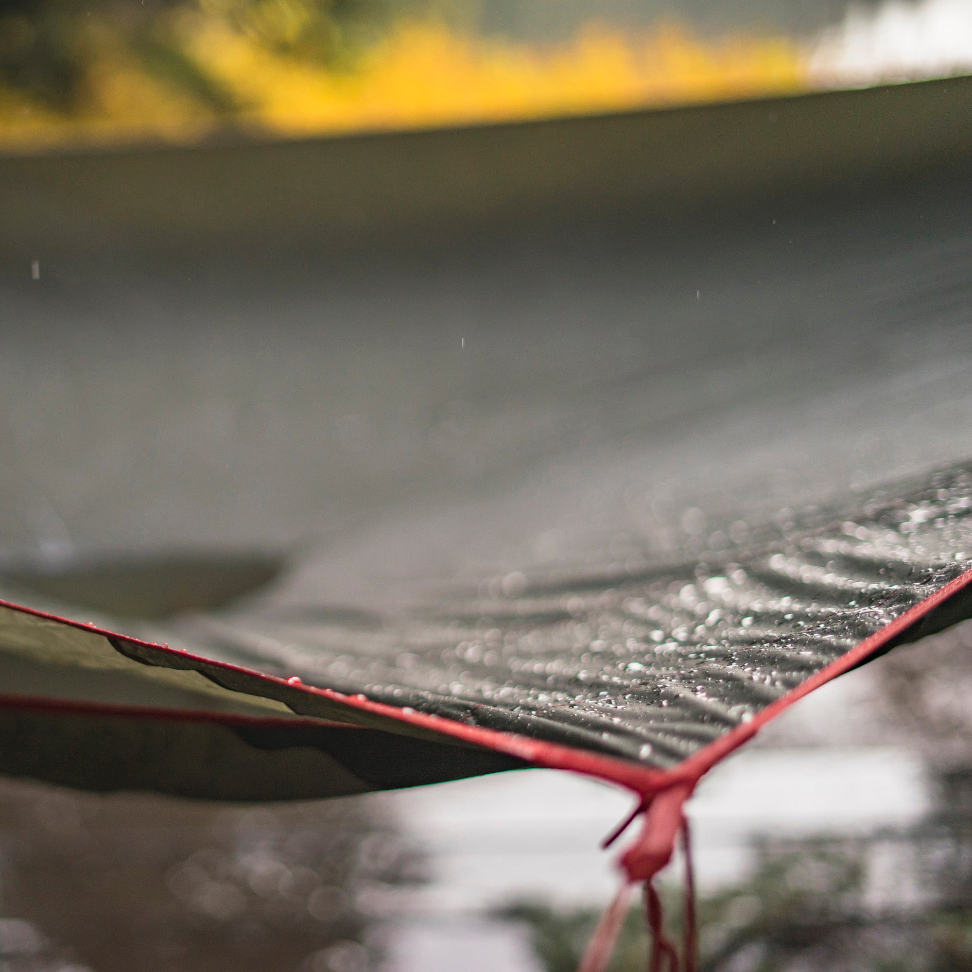 GrandTrunk Abrigo Rain Fly and Shelter set up outdoors, showcasing lightweight waterproof shelter for camping and rain protection.
