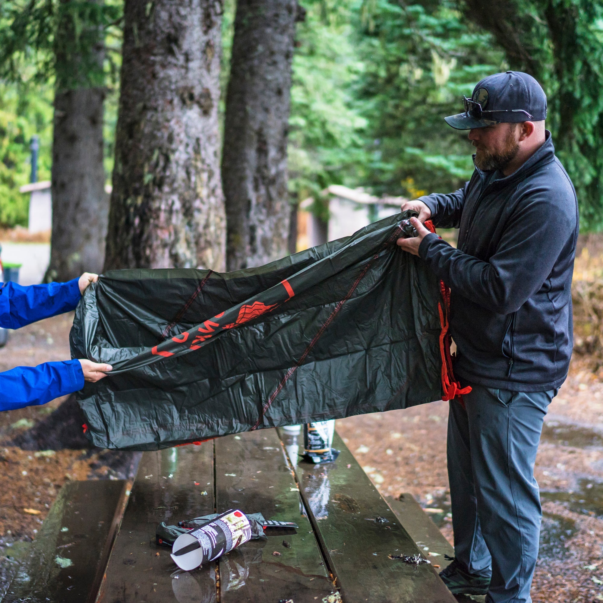 GrandTrunk Abrigo Rain Fly and Shelter set up outdoors, showcasing waterproof fabric and lightweight design for camping protection.