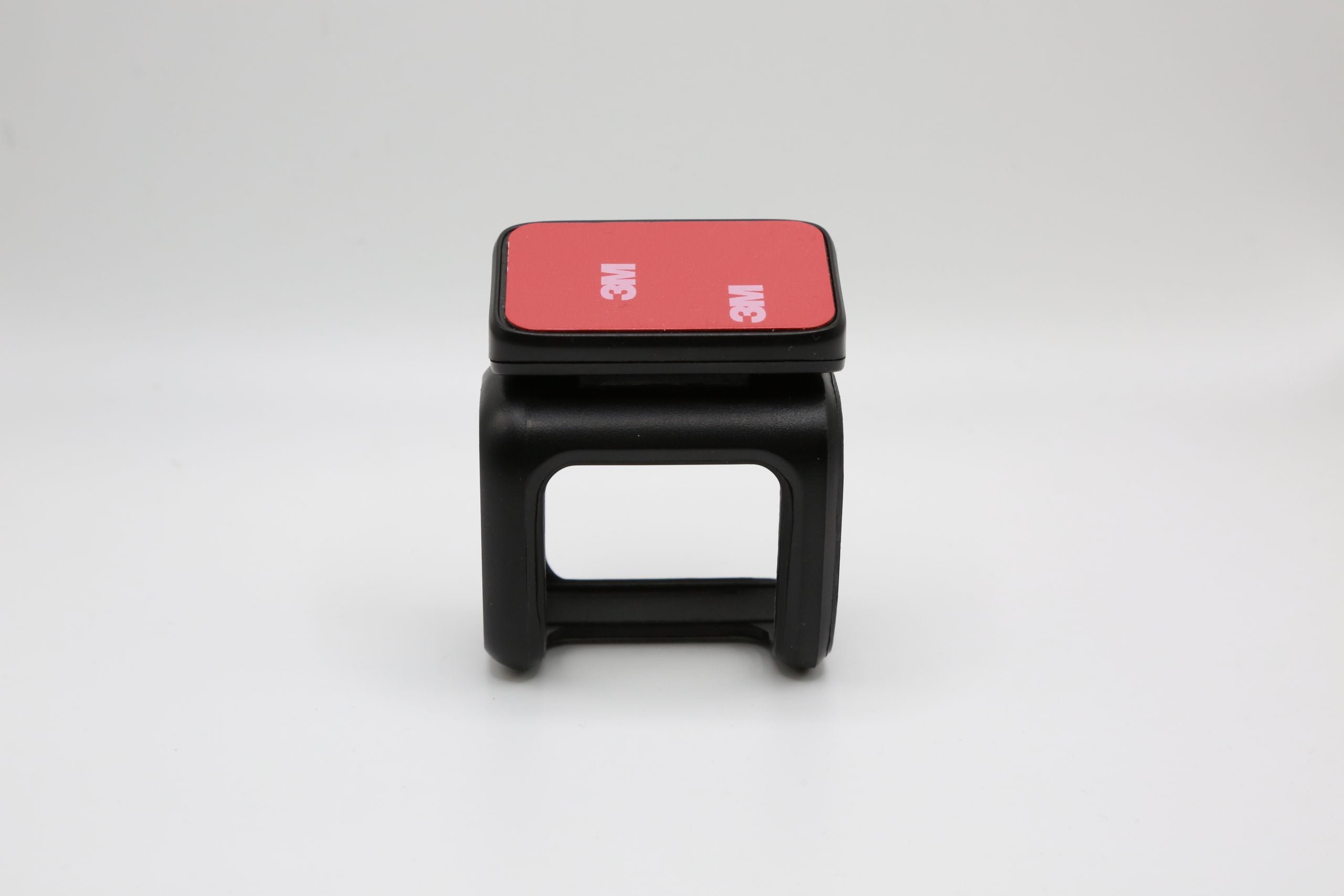 Rexing adhesive mount for DT2 dash camera, black plastic with mounting pad, designed for secure attachment and easy installation.