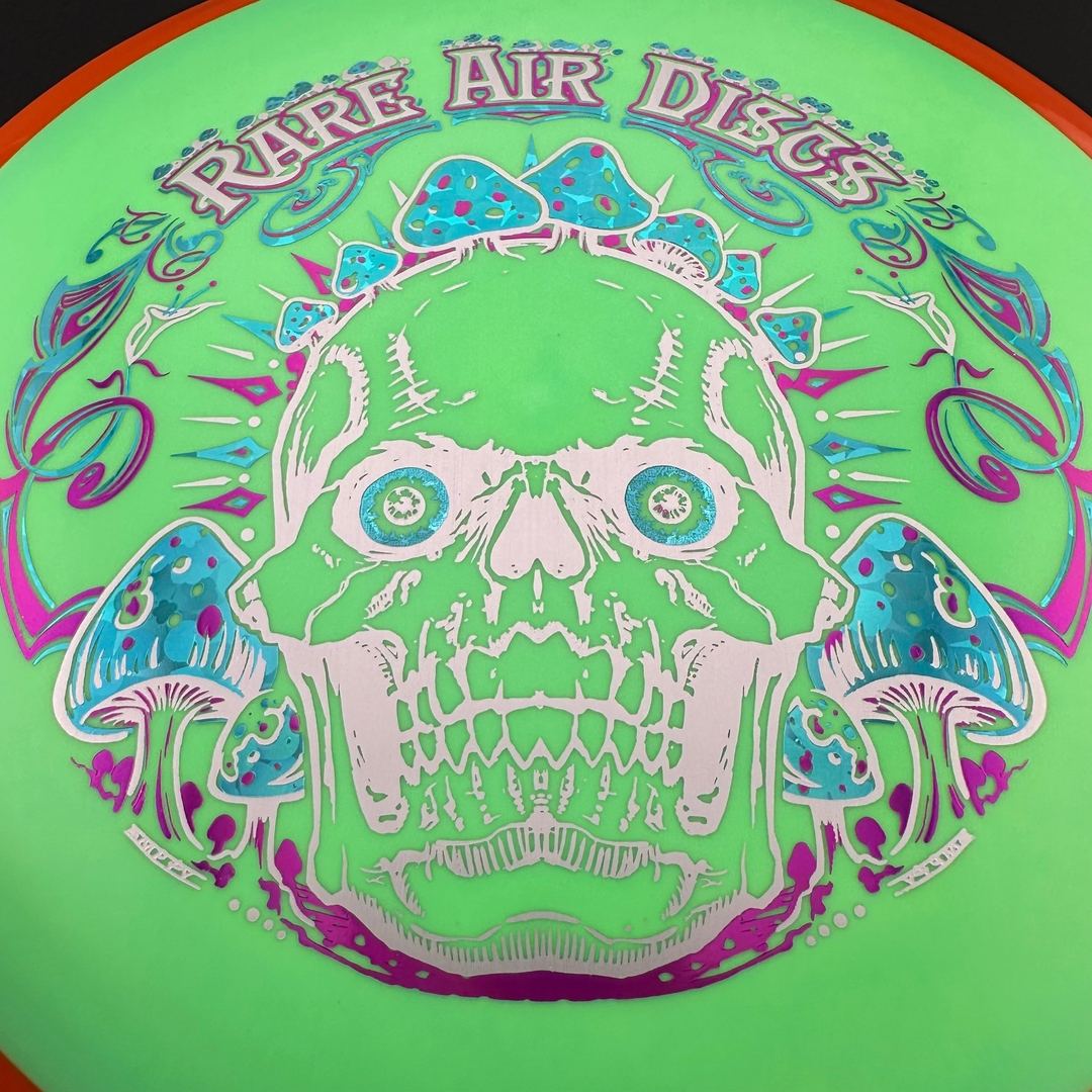 Rare Air Discs Fission Defy Crushin' Amanitas VIP 2.0 disc golf disc with colorful design and bold branding on the flight surface.
