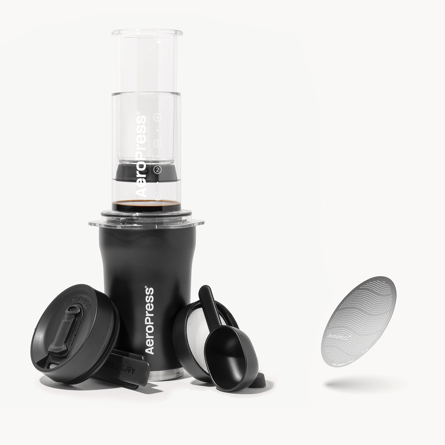 Aeropress coffee maker with components on a white background