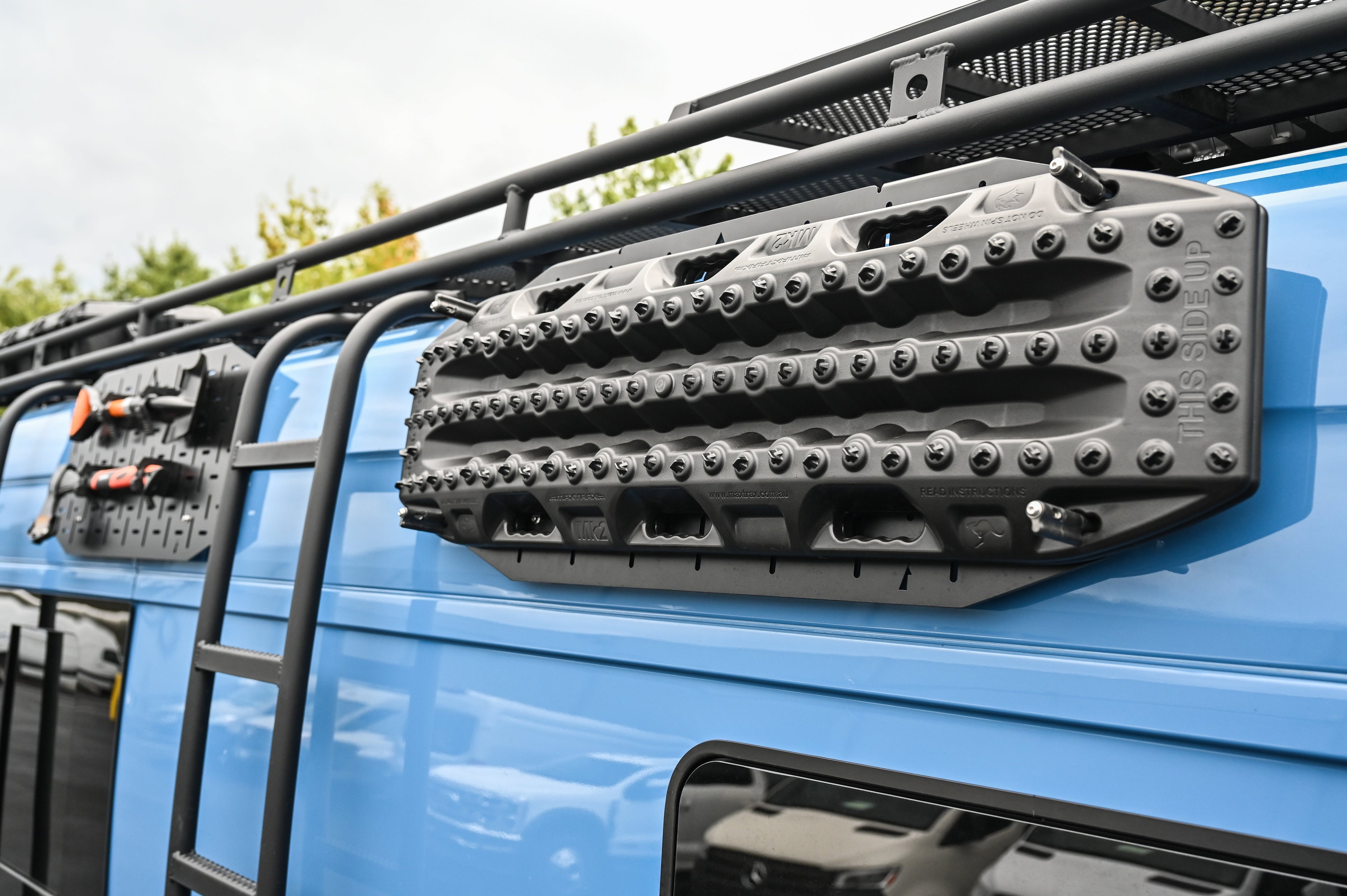 Alpine Van Works Alpaca Cargo Plate™️ exterior component for Sprinter vans, showing the durable aluminum plate installed on the vehicle.