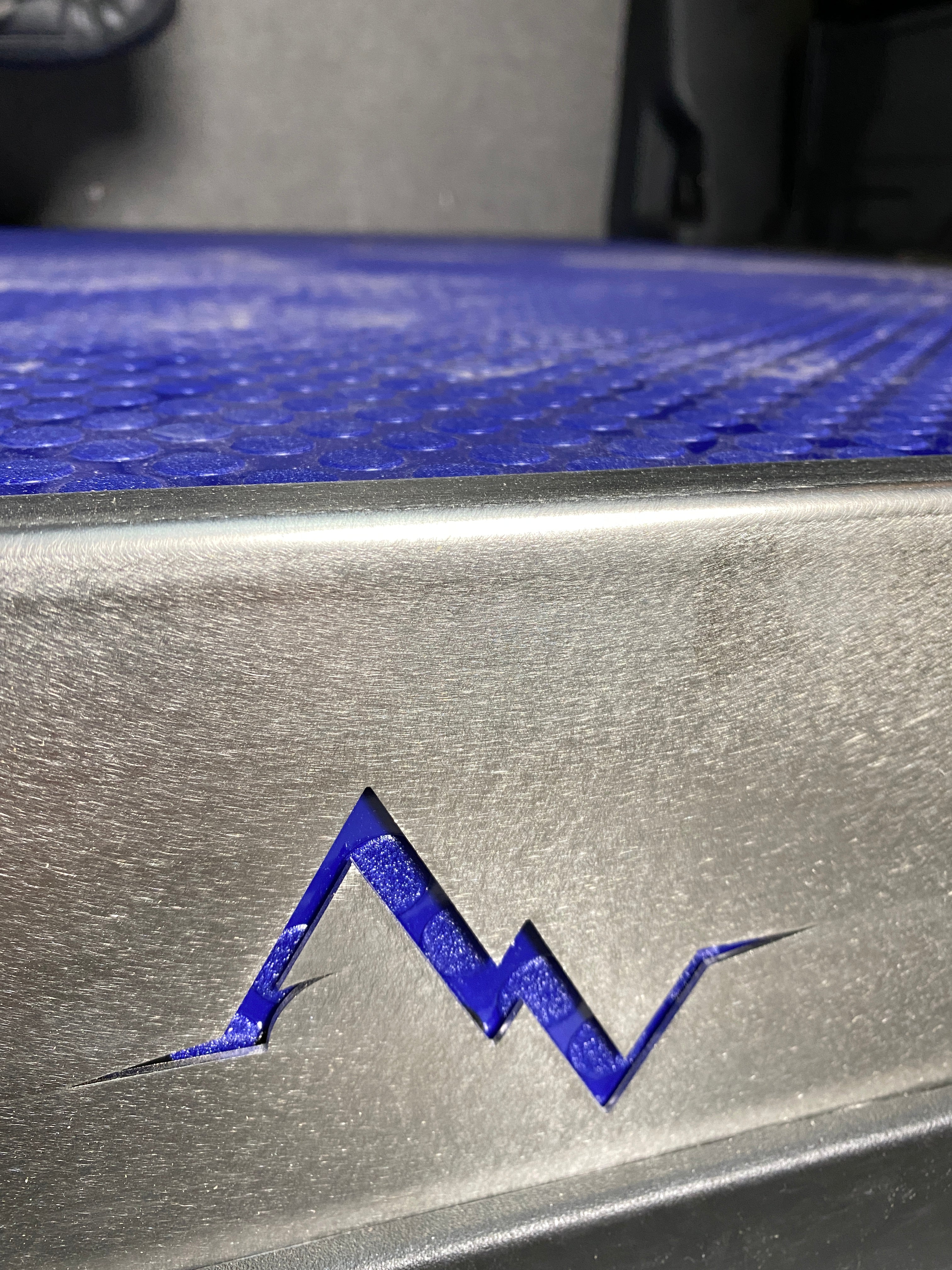 Close-up of Alpine Van Works insulated Sprinter van floor kit with trim details and durable flooring materials.