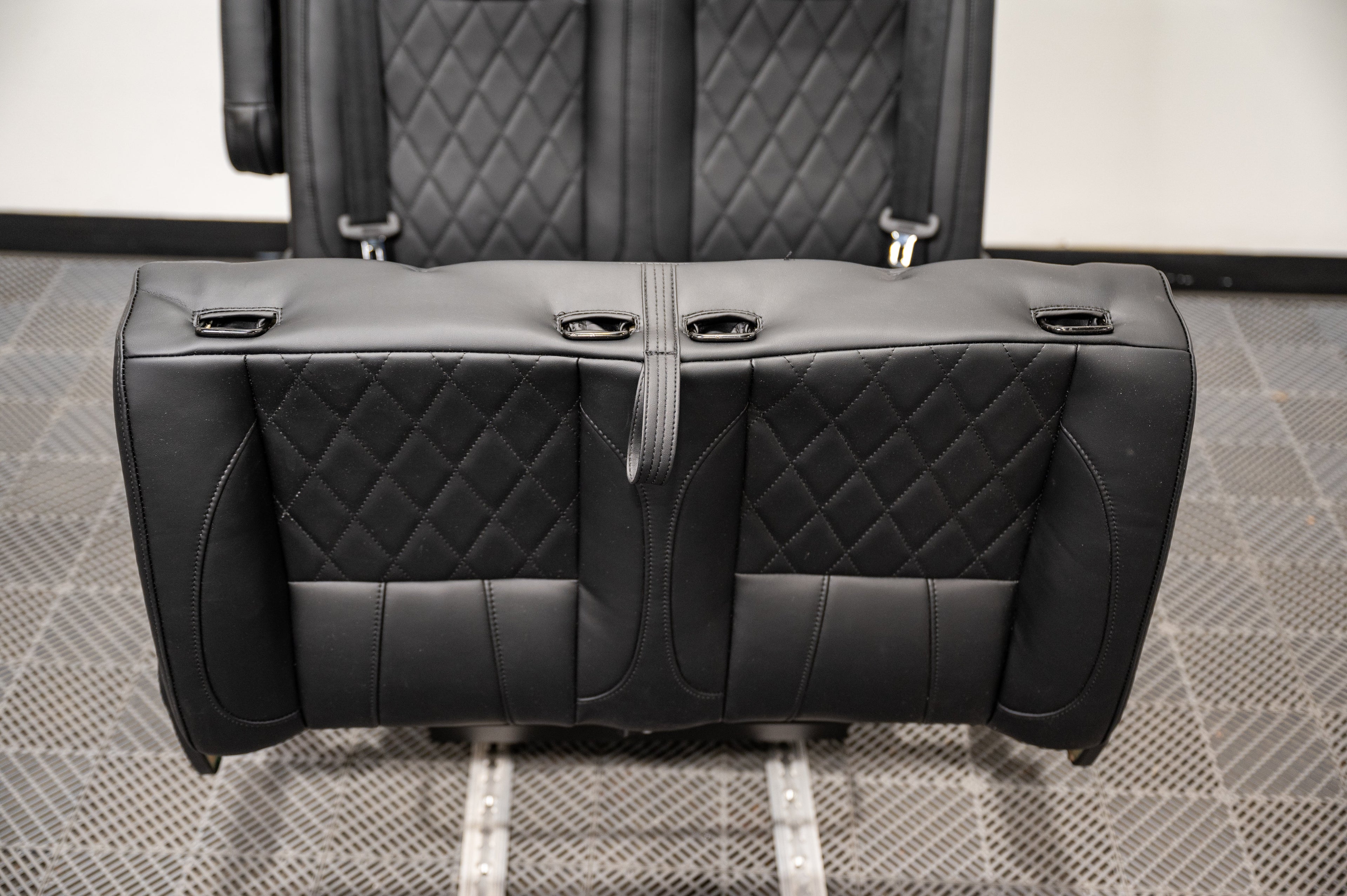 Alpine Van Works dual fold double bench-to-bed seat with cushioned seating and fold-down bed feature, ideal for versatile vehicle seating.