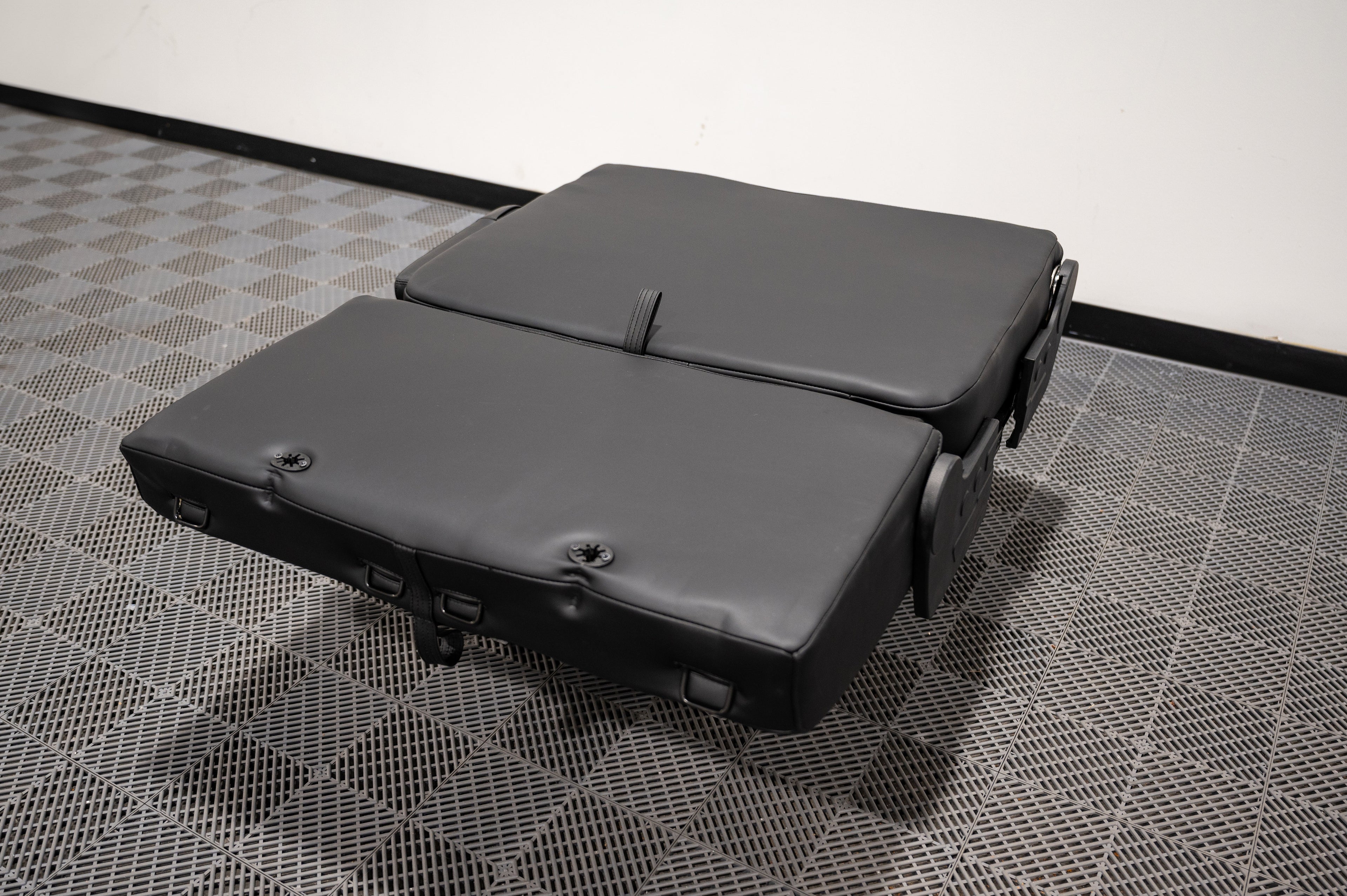 Alpine Van Works dual fold double bench-to-bed seat showing its compact folded and extended seating and sleeping configuration.