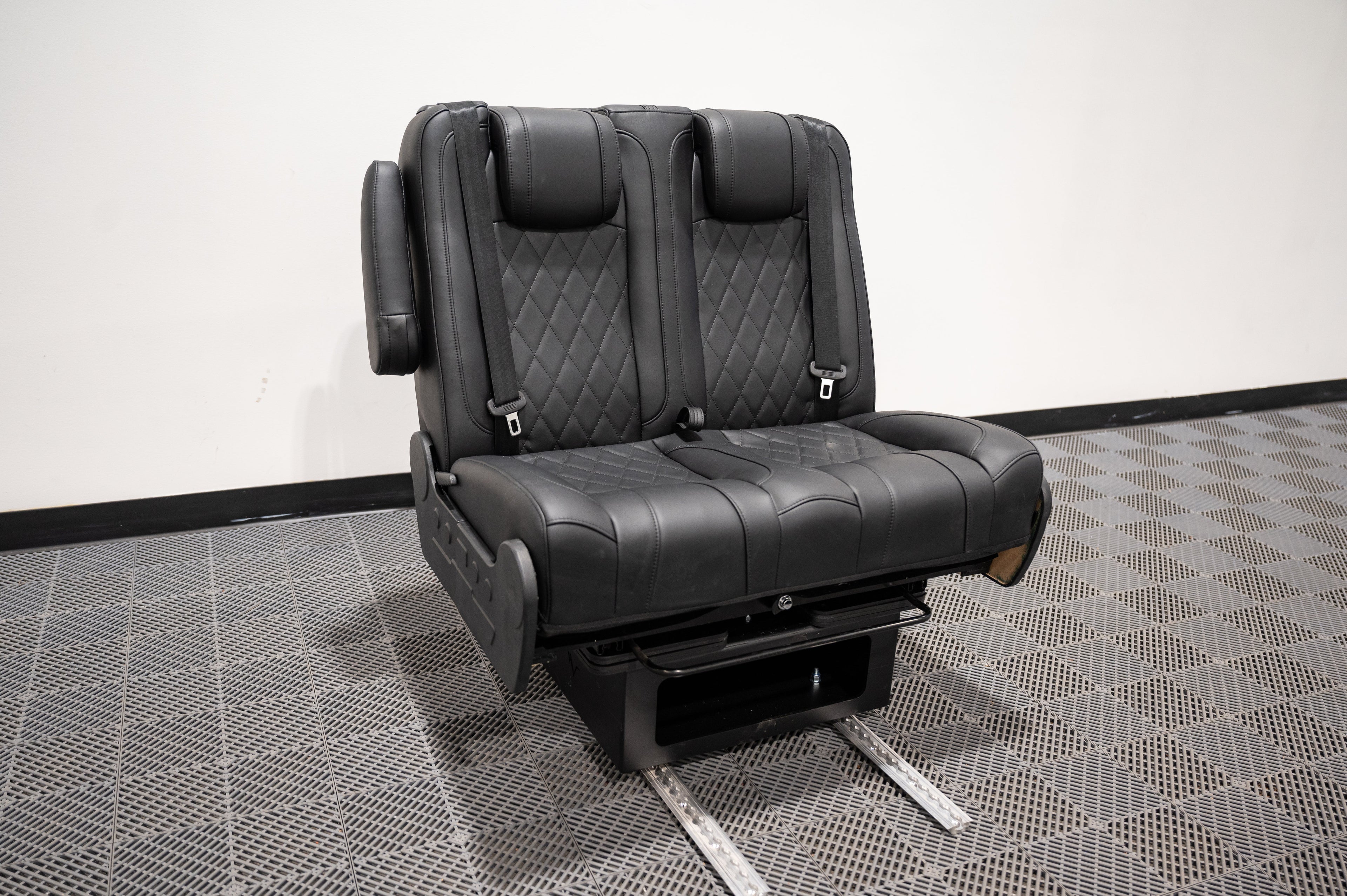 Alpine Van Works dual fold double bench seat that converts into a bed, featuring cushioned seating and sturdy frame.