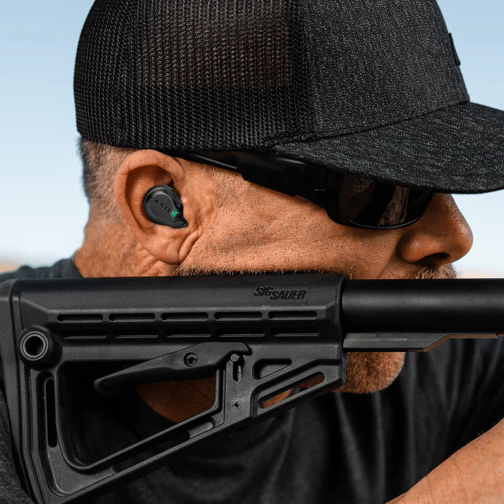 HCC Tactical XCOR Earbuds in use, showcasing Bluetooth functionality for hearing protection and communication.