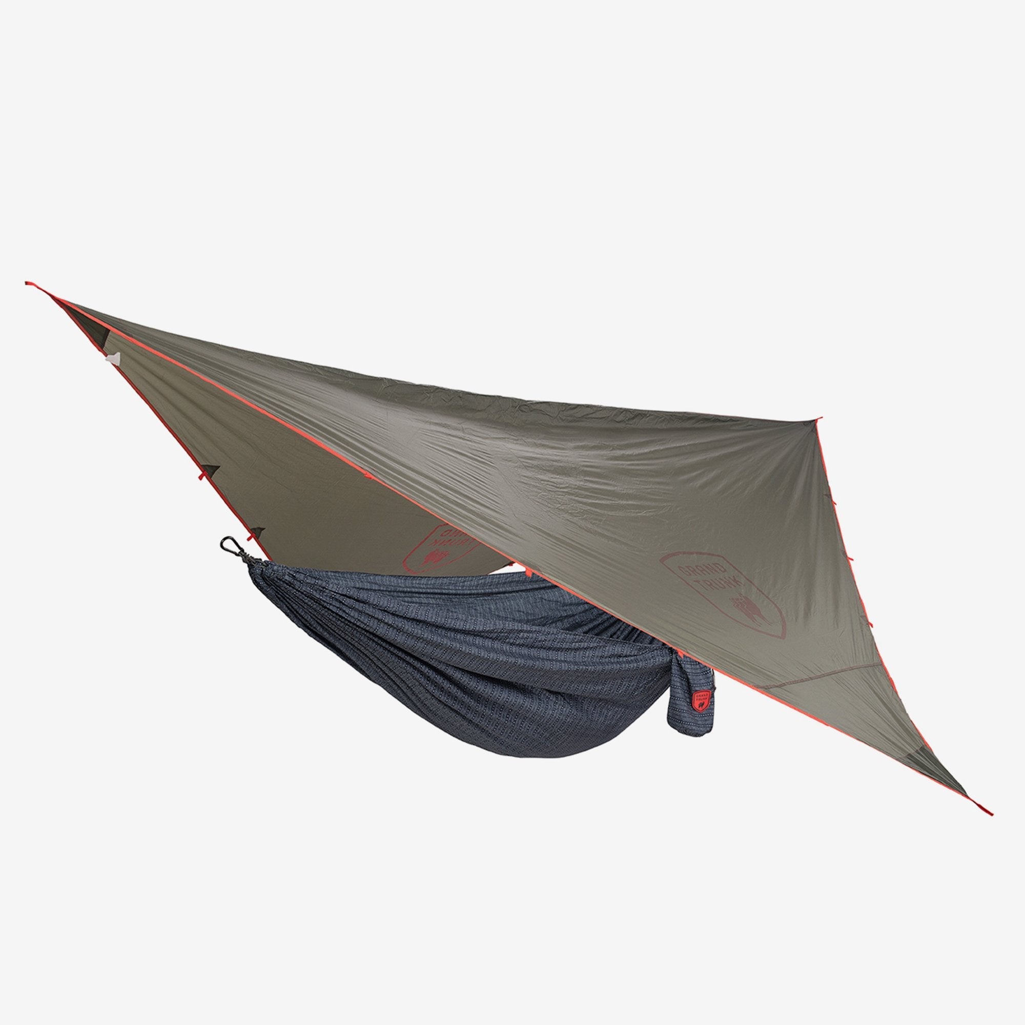 GrandTrunk Abrigo rain fly shelter set up over a hammock, providing waterproof protection and shelter during outdoor camping.