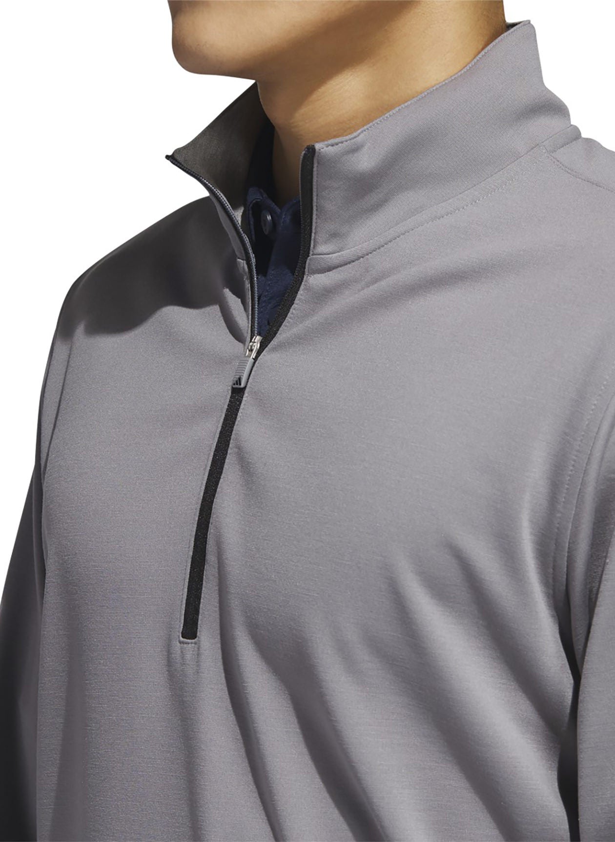 Adidas Elevated Quarter-Zip Golf Pullover in stylish design, worn by a golfer on the course, showcasing athletic apparel for golf.