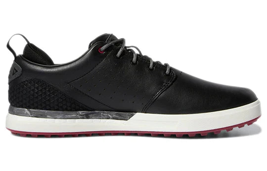 ParWestGolf Adidas FLOPSHOT spikeless golf shoes with black and white design, showing the athletic footwear on a golf course.