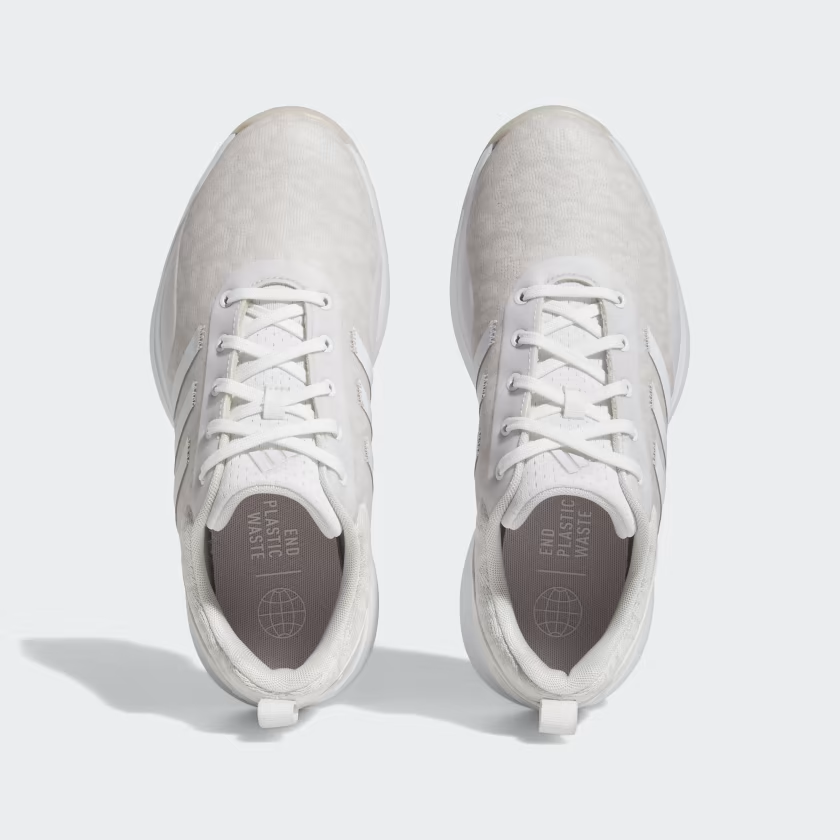 Adidas women's S2G golf shoes with white and green design, featuring sporty laces and textured sole for outdoor golf course play.