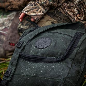 Backcountry Sportsman blind bag featuring Alexandra Sandberg hunting gear, shown with outdoor accessories and tactical design.