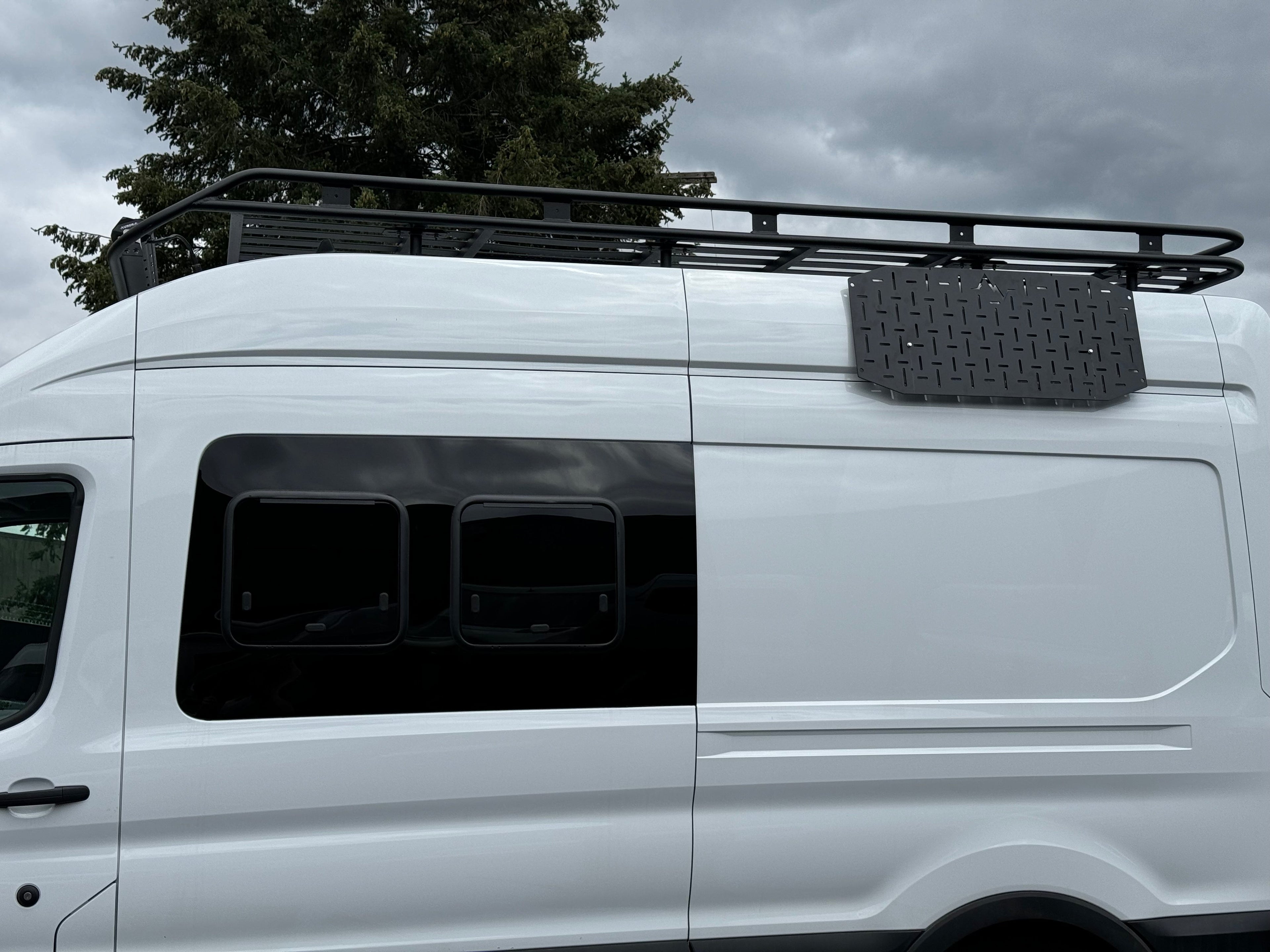Alpine Van Works Alpaca Cargo Plate for Transit van, exterior component showing durable aluminum construction with mounting points.