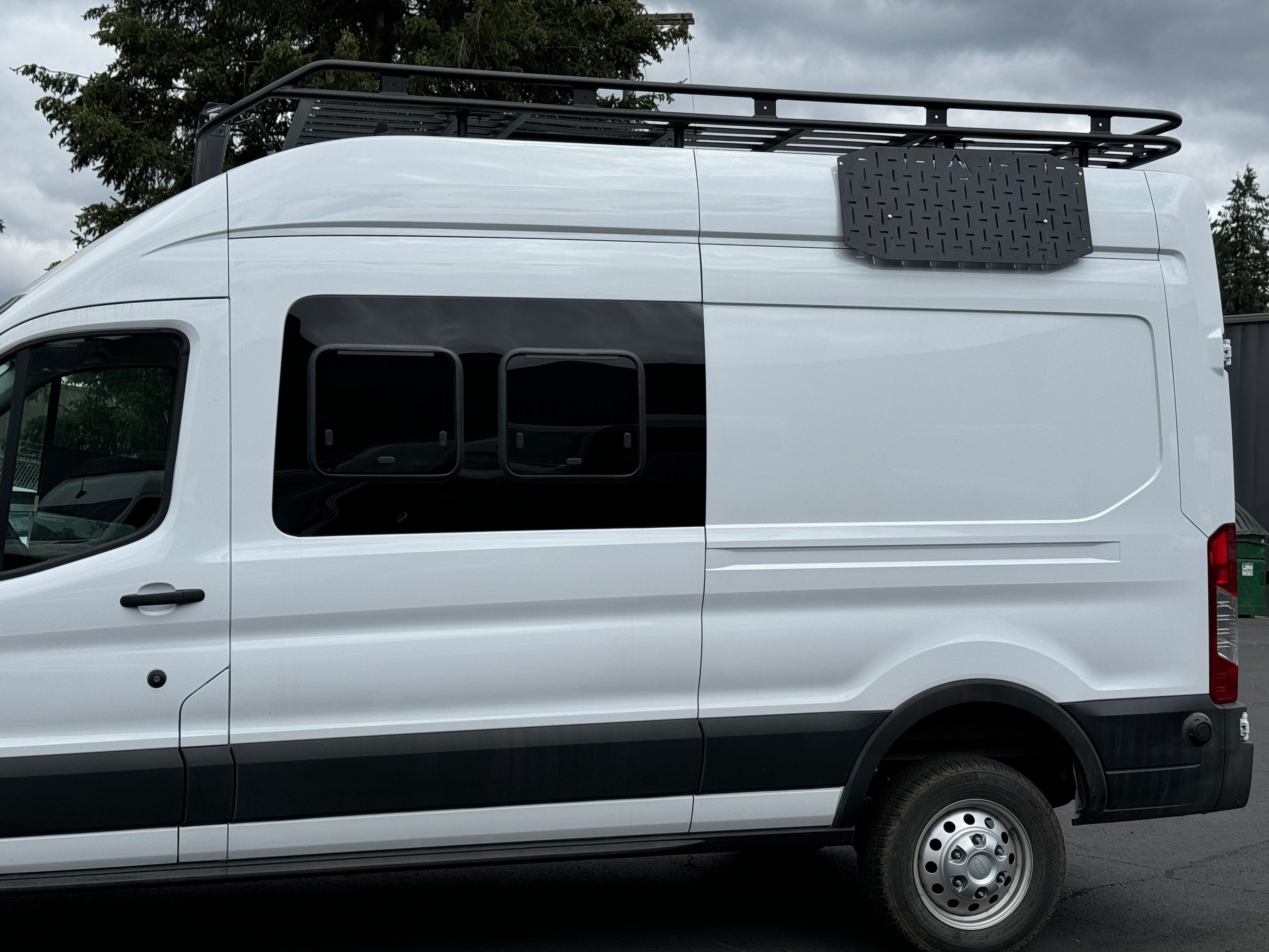 Alpine Van Works Alpaca Cargo Plate for Transit van exterior component, durable metal plate with mounting holes for cargo security.