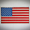 American flag made from recycled fire hose by Recycled Firefighter, showcasing vibrant colors and unique texture.