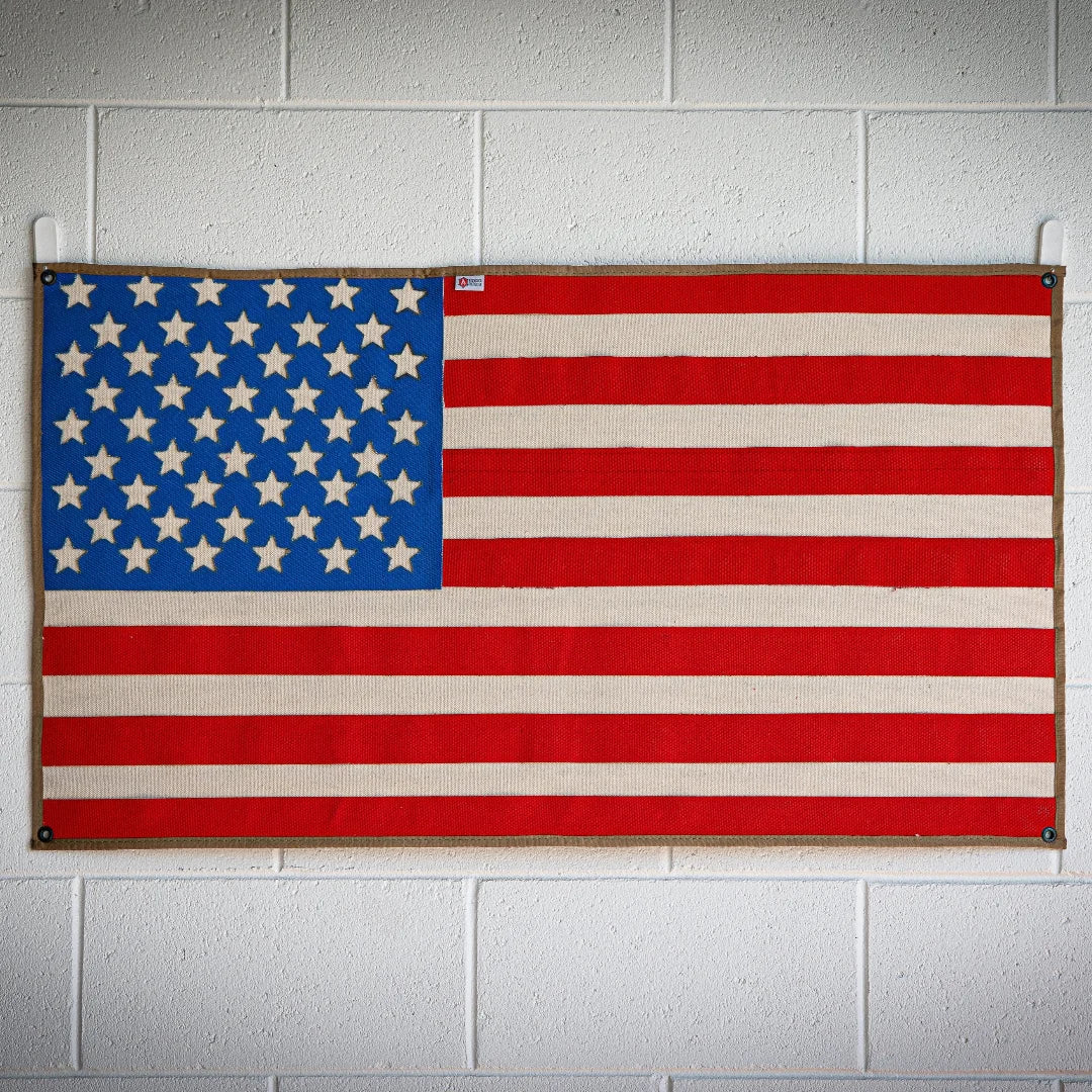 American flag made from recycled fire hose by Recycled Firefighter, showcasing vibrant colors and unique texture.