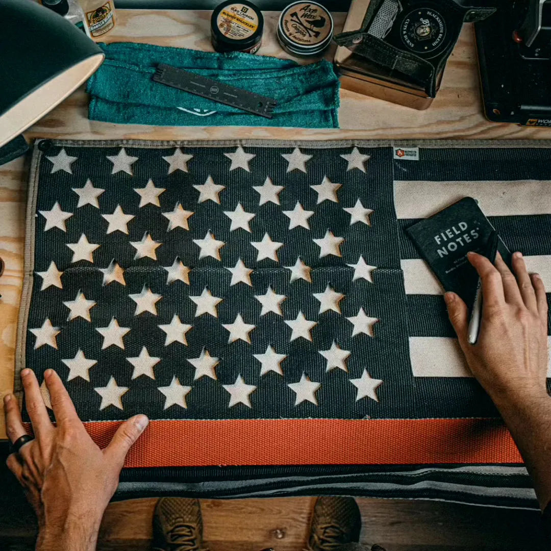 American flag made from fire hose with thin red line, symbolizing support for firefighters, on a white background.