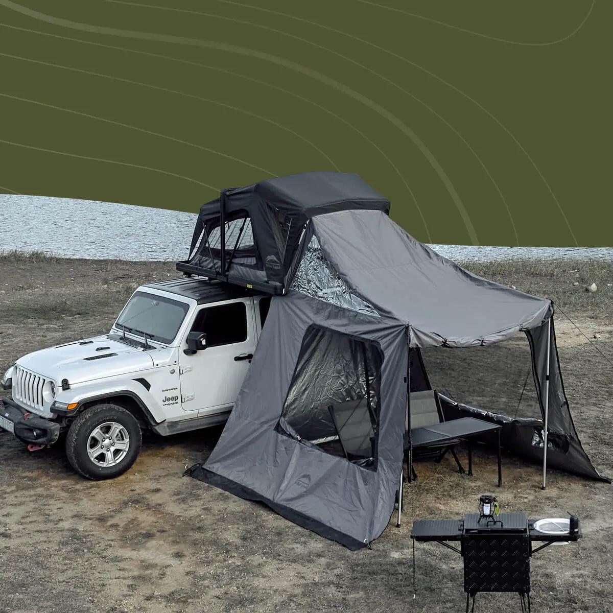 Wild Land Annex side car awning attached to OrthFrame Summit Explorer camping setup, showing outdoor gear and tent extension.