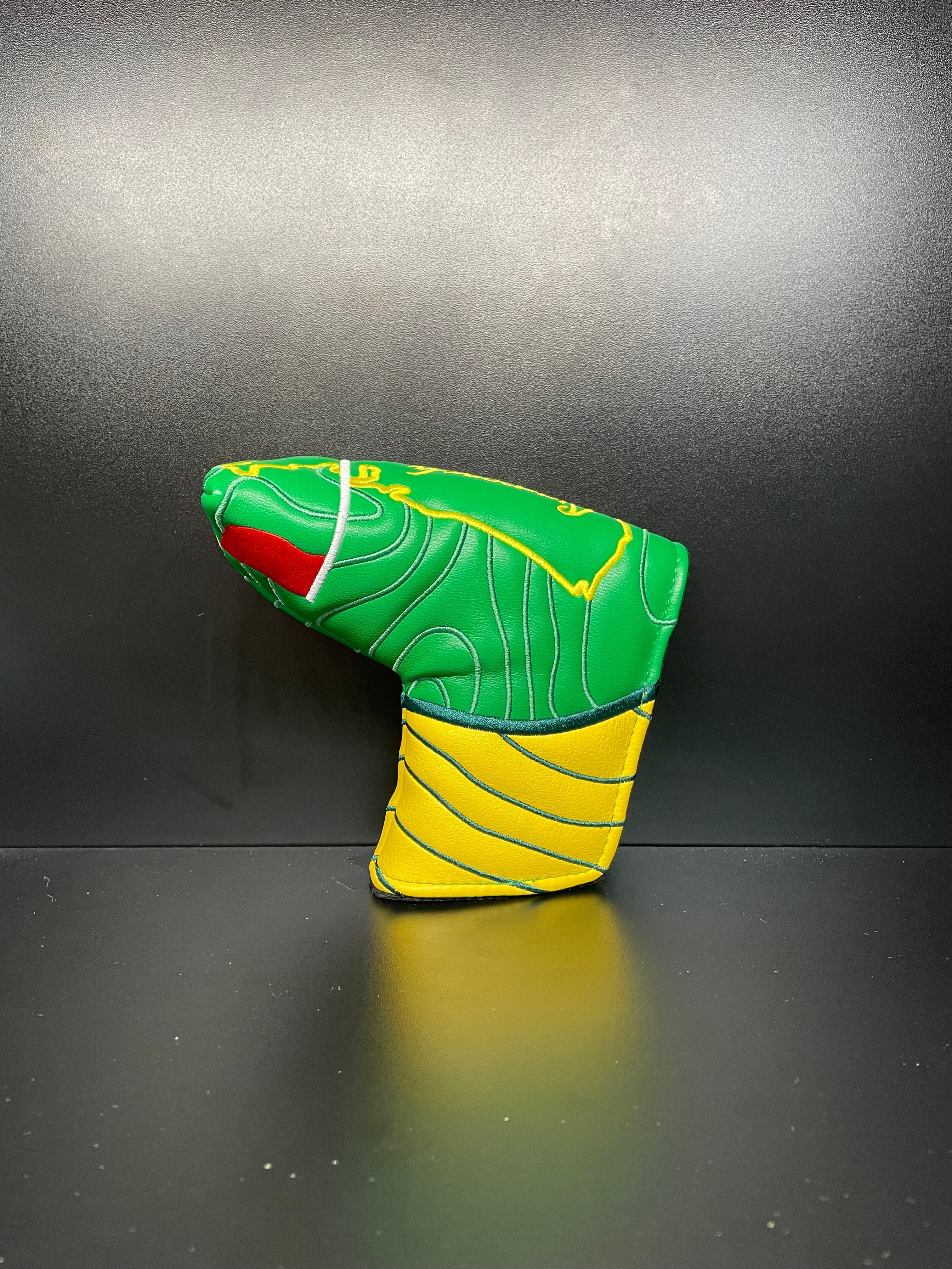 Approaching Masters golf club headcover by ParWestGolf featuring a detailed design in black and green for driver protection.