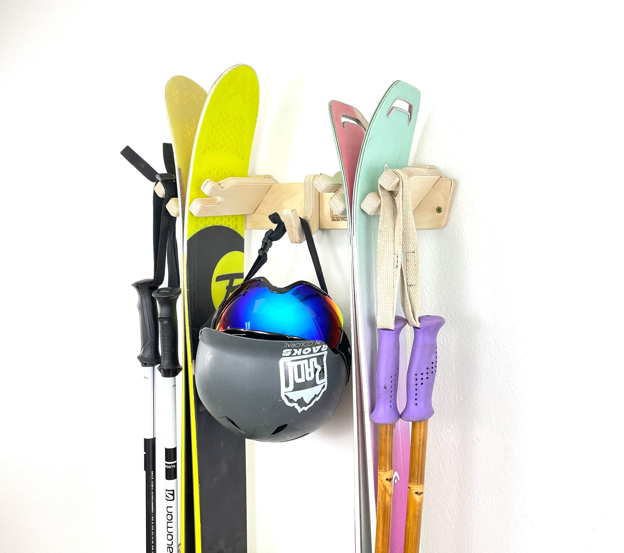 Rado Racks THE APRES ski wall rack holding skis and poles, mounted on a wall for organized ski storage.