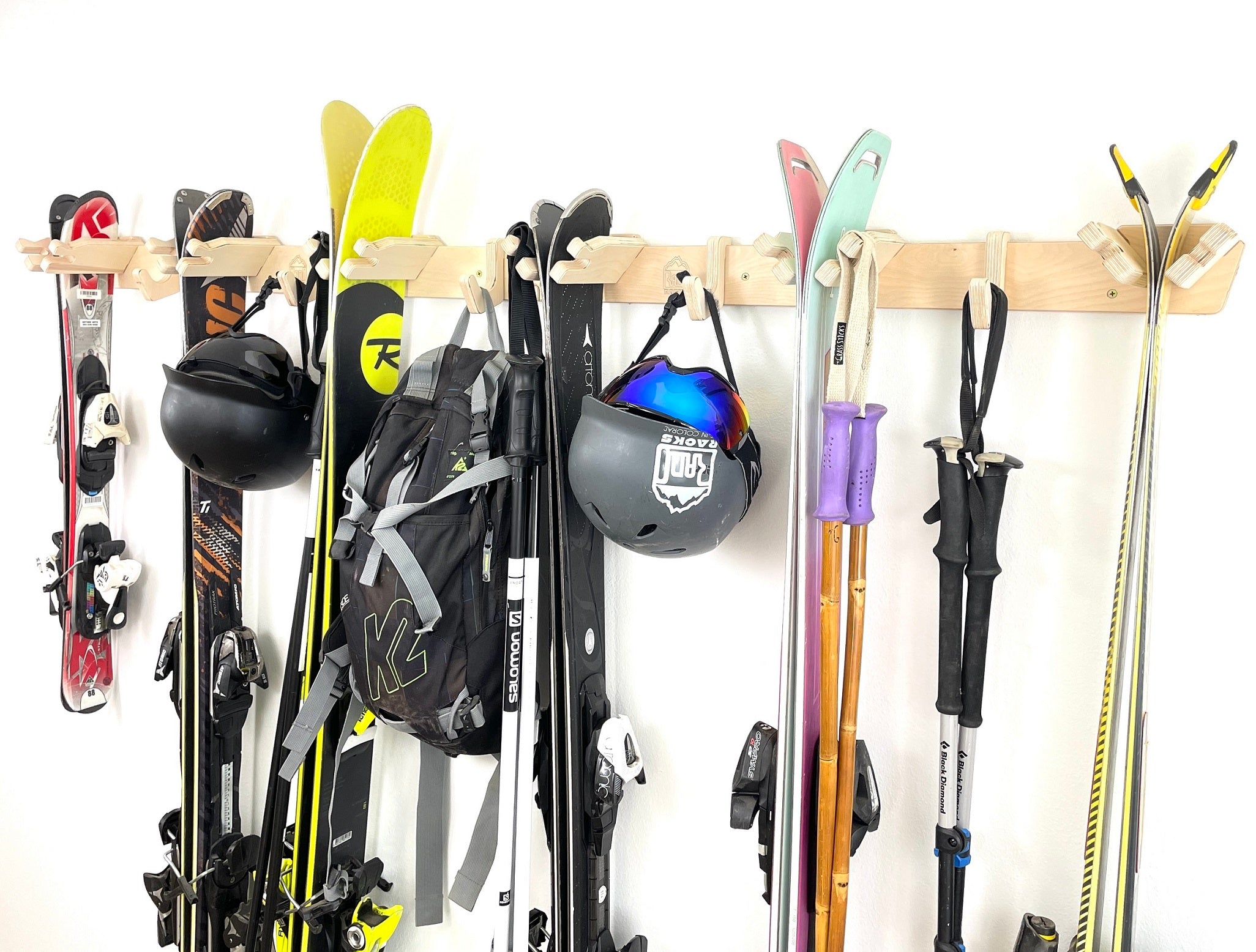 Rado Racks THE APRES ski wall rack holding multiple skis, mounted on a wall for organized ski storage.