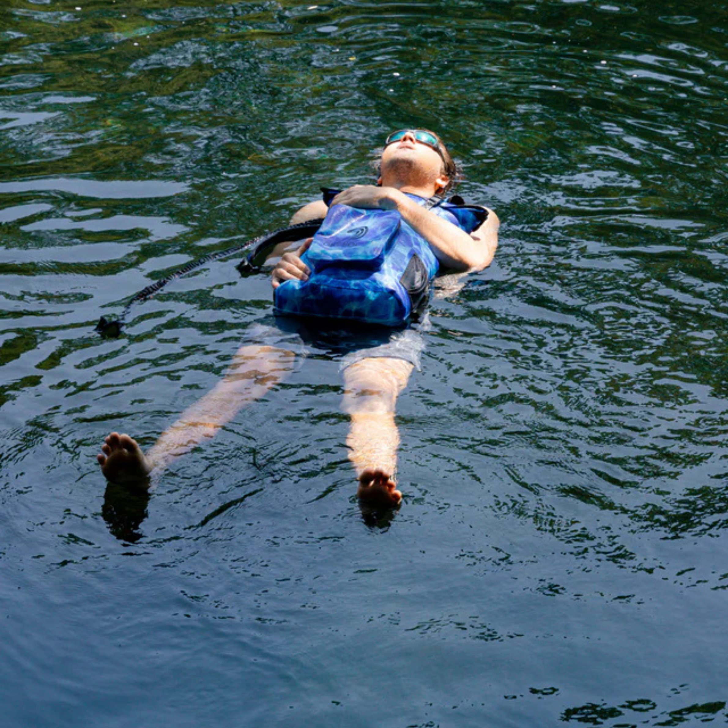Aqua blue Dry Pocket waterproof floating backpack dry bag for outdoor and water activities, showing its durable, secure closure.