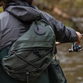 Backcountry Sportsman sling pack with adjustable strap and multiple compartments, shown on a neutral background.