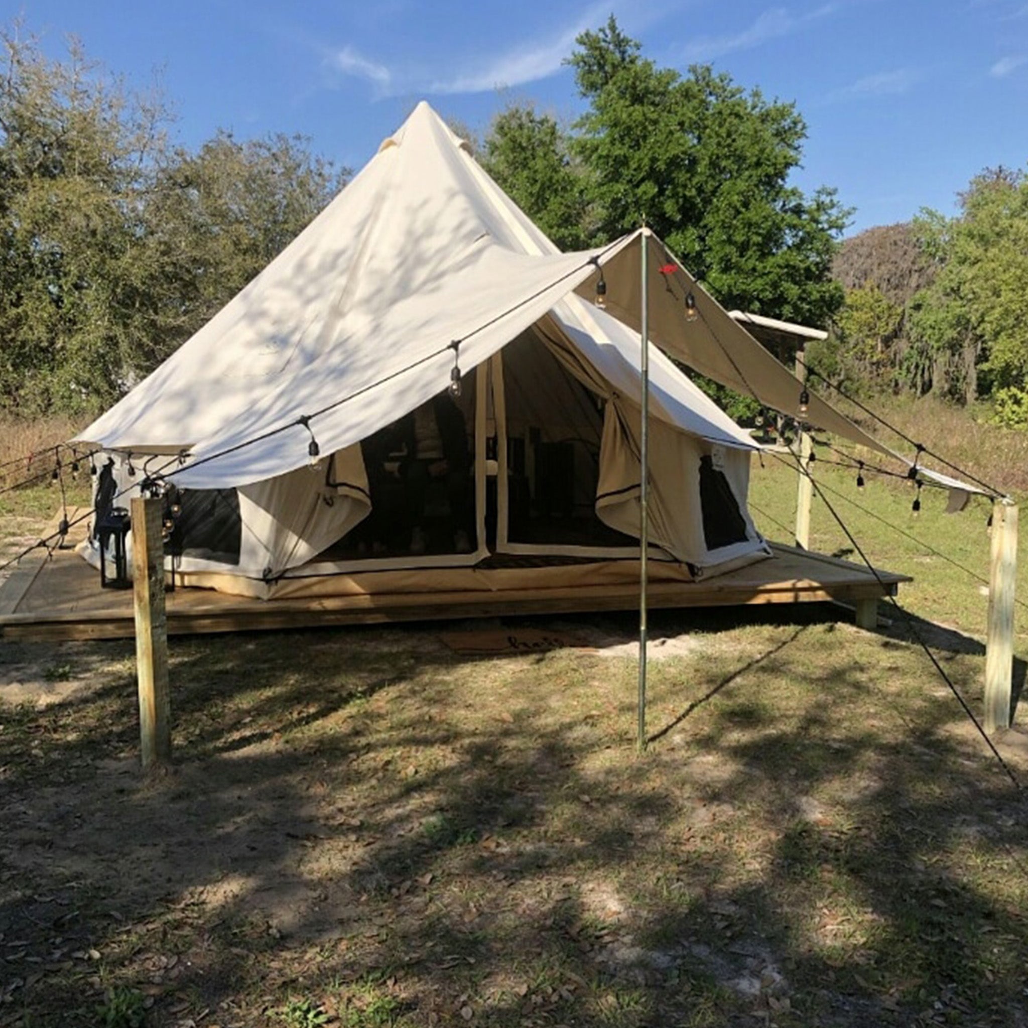 White Duck Outdoors Regatta awning attached to a bell tent, providing outdoor shelter and shaded space.