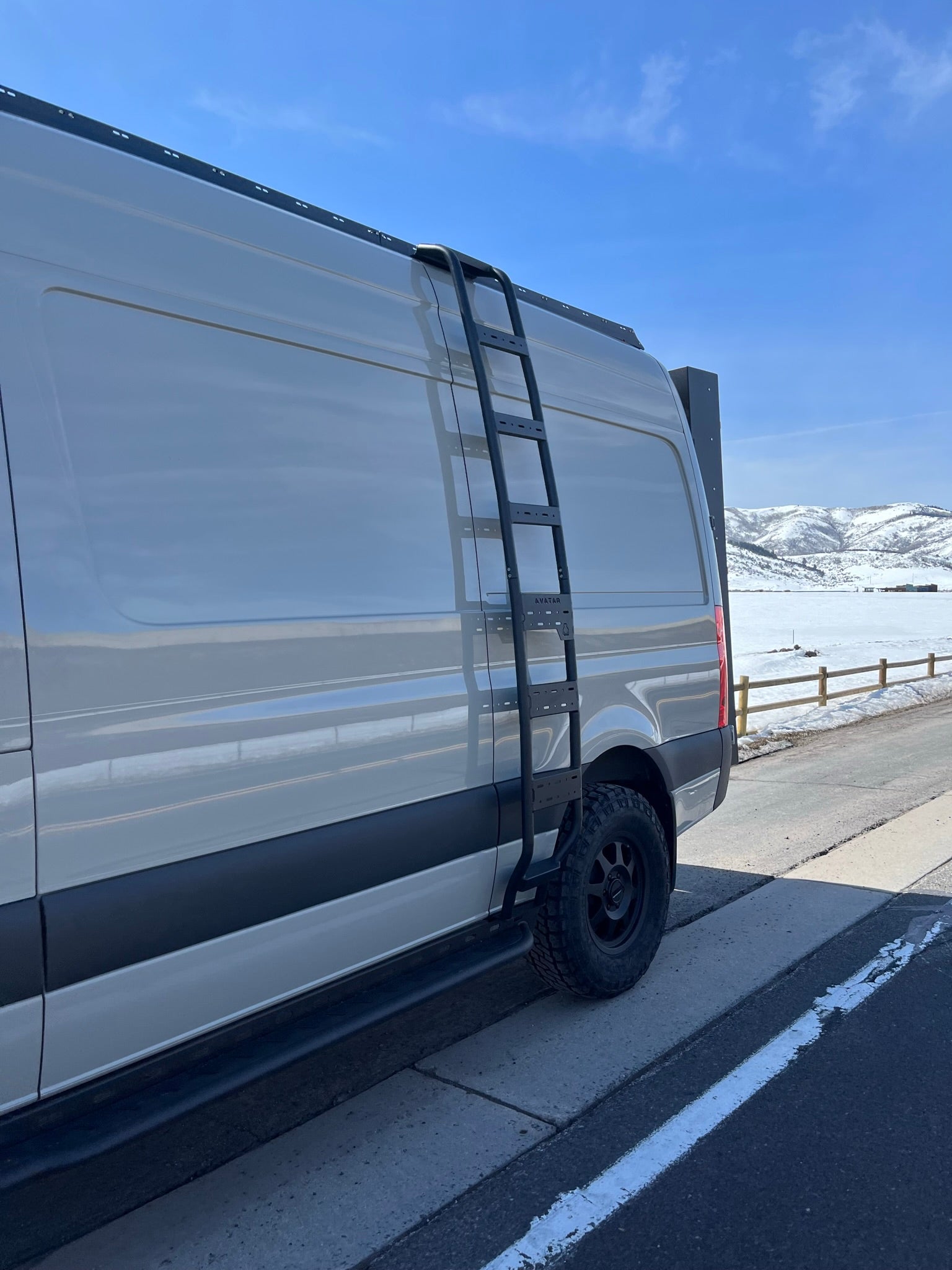 Avatar Offroad Ultra Rack low profile roof rack installed on a Sprinter van, providing durable cargo storage and roof mounting solution.
